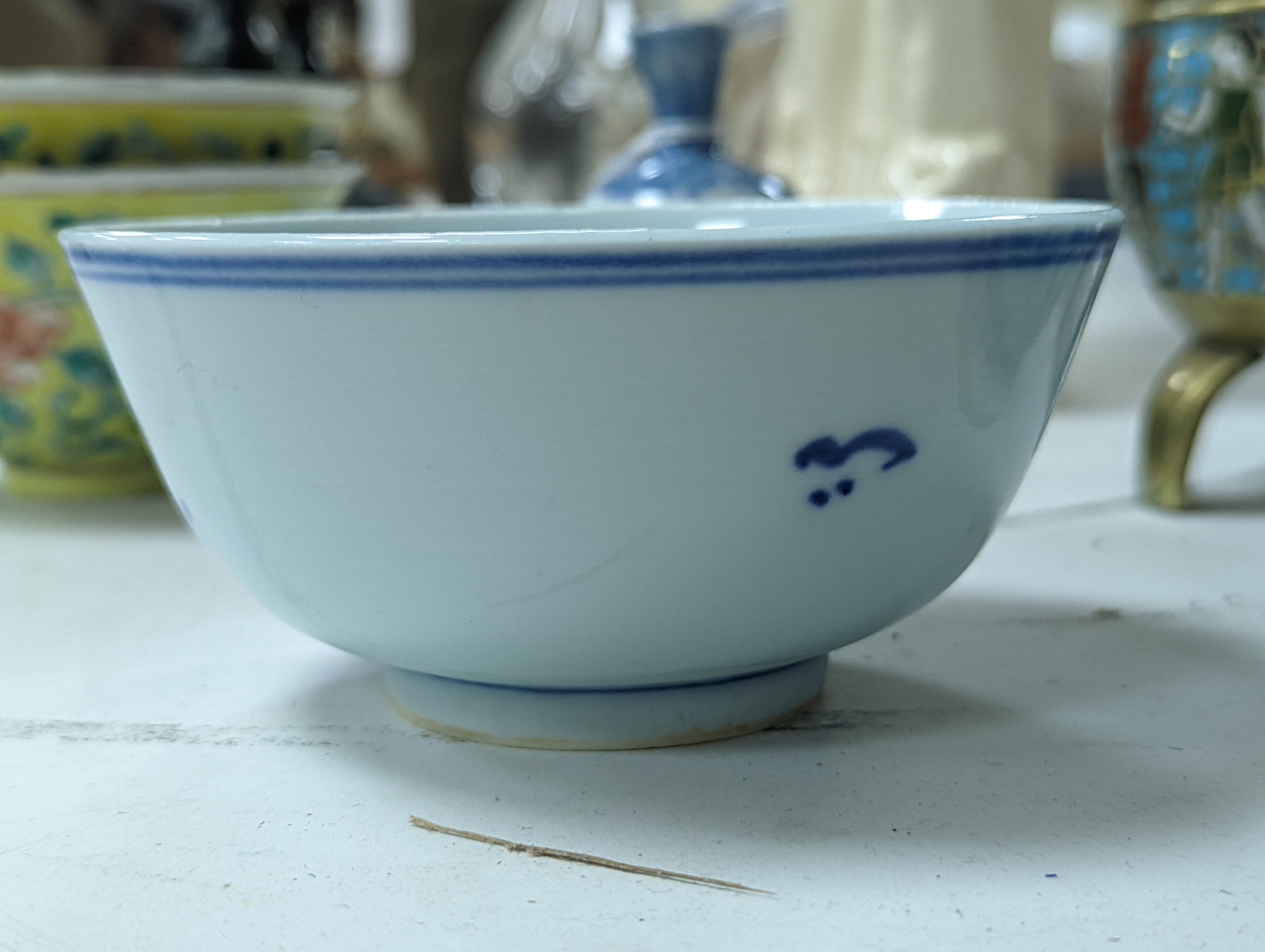 A group of Chinese porcelain, 19th /20th century, to include a pair of yellow ground bowls, 10.8 cm diameter, a blue and white vase, Xuande mark, a similar bowl and vase, and a champleve enamel bronze koro and cover